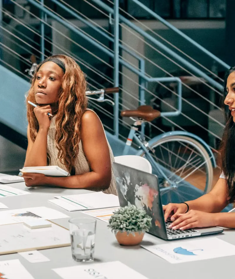 Creative marketing team collaborating around a workspace table